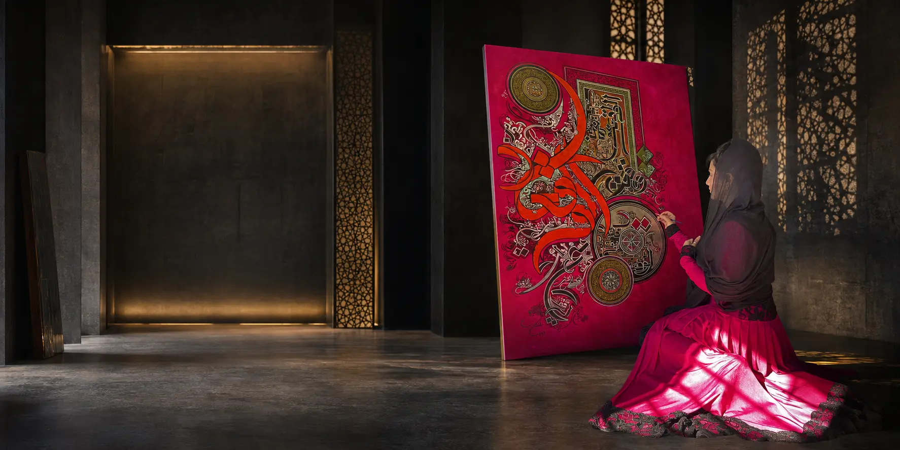 Ayesha Kamal painting a monumental crimson calligraphic work